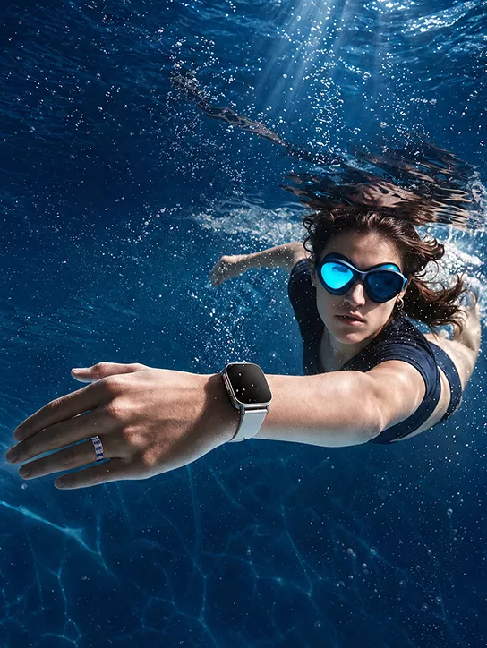 A model wearing a sports watch underwater.