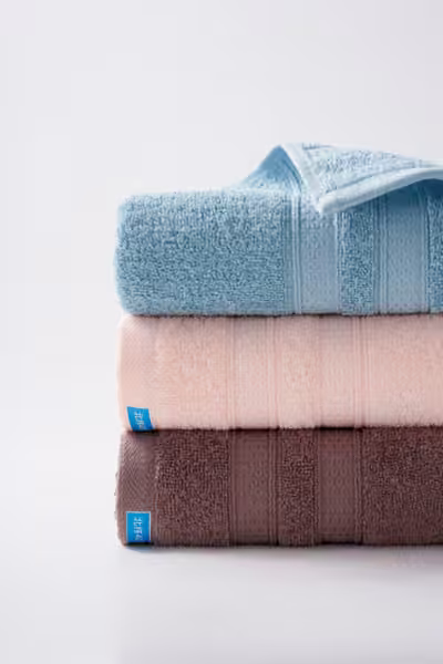 Pastel and chocolate cotton towel stack, home textile product photography by Southlake Vision in China.
