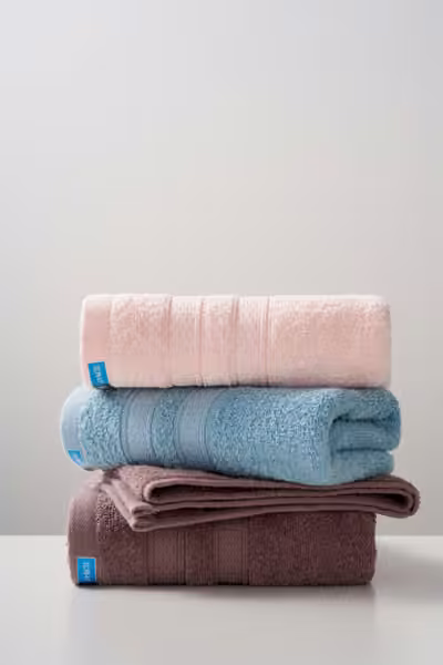 Folded towels with woven band detail, home textile product photography by Southlake Vision in China.