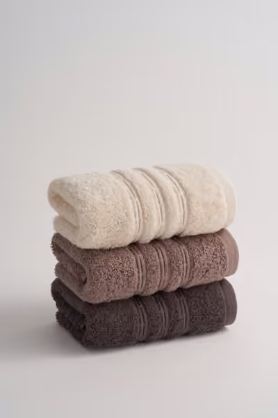 Neutral rolled towel stack, home textile product photography by Southlake Vision in China.