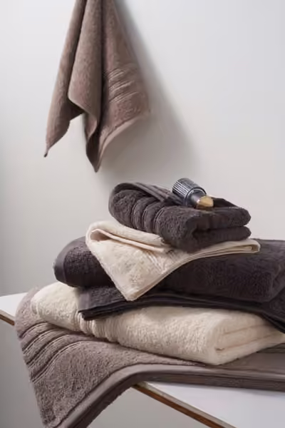Hanging and folded neutral bath towels, home textile product photography by Southlake Vision in China.