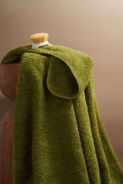 Green bath towel with sculptural styling, home textile product photography by Southlake Vision in China.