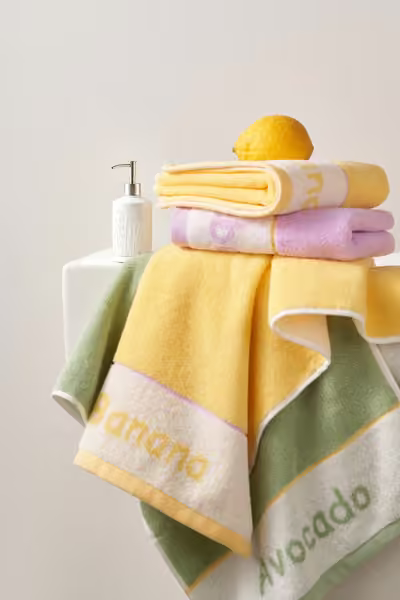 Yellow and lavender towels with bathroom accessories, home textile product photography by Southlake Vision in China.