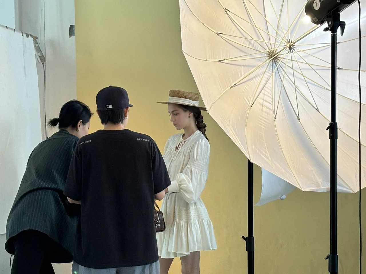 Southlake Vision production team preparing a model shoot with studio lighting.